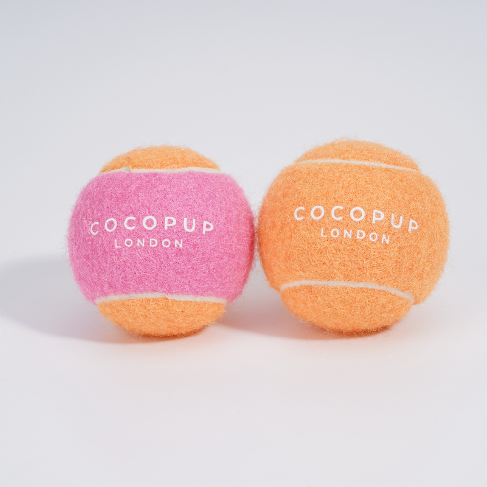 Der pink-orangefarbene Tennisball von COCOPUP bringt Farbe ins Spiel und sorgt für endlosen Spaß und Bewegung.