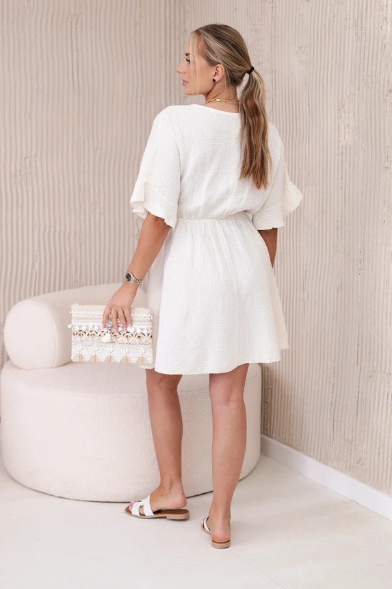 Dieses Musselinkleid in hellem Beige kommt mit einem eleganten Bindegürtel, der die Taille betont und für einen femininen Touch sorgt. Vielseitig und bequem.